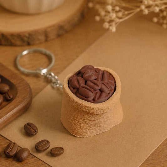 Kuma Labs Coffee Sack Clicker — front view showing textured sack detail