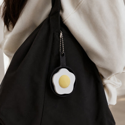 Kuma Labs Fried Egg Clicker — lifestyle photo on morning desk