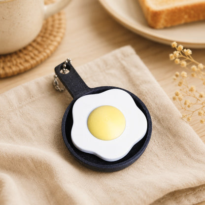 Fried Egg Clicker pocket comfort object — cozy aesthetic flat lay