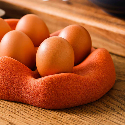 Kuma Labs Morning Egg Nest — grabbing an egg from the nest