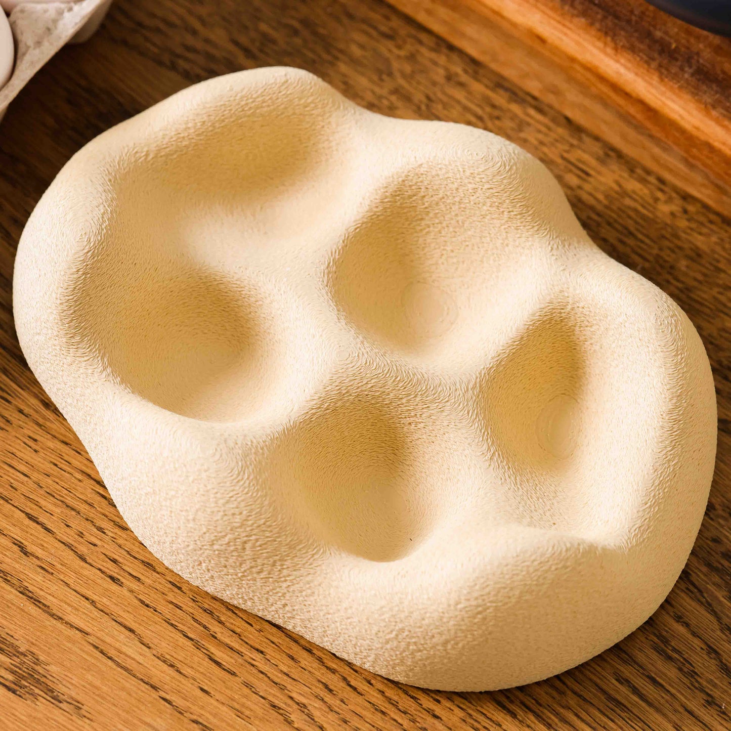 Kuma Labs Morning Egg Nest — eggs settling into the five contoured wells