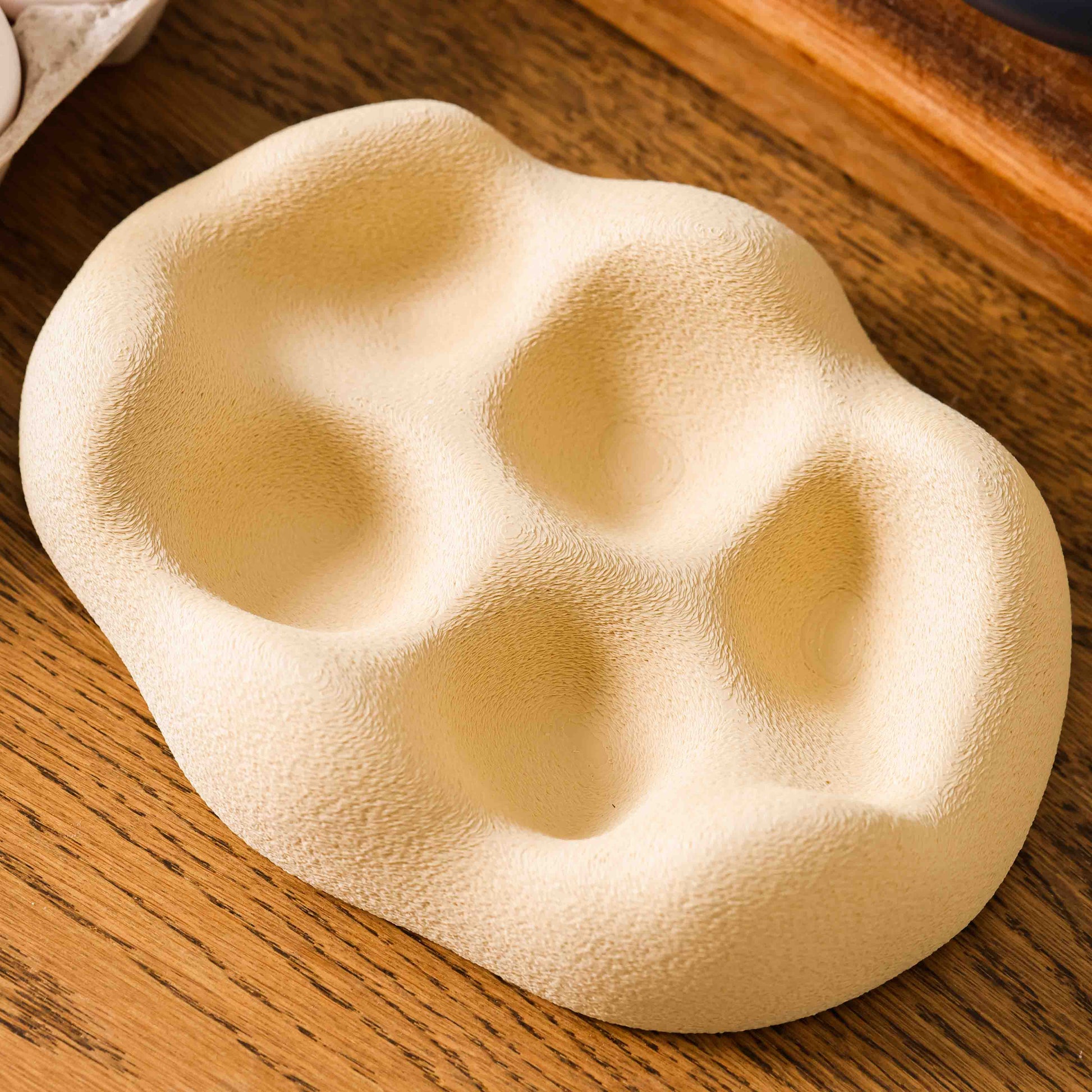Kuma Labs Morning Egg Nest — eggs settling into the five contoured wells